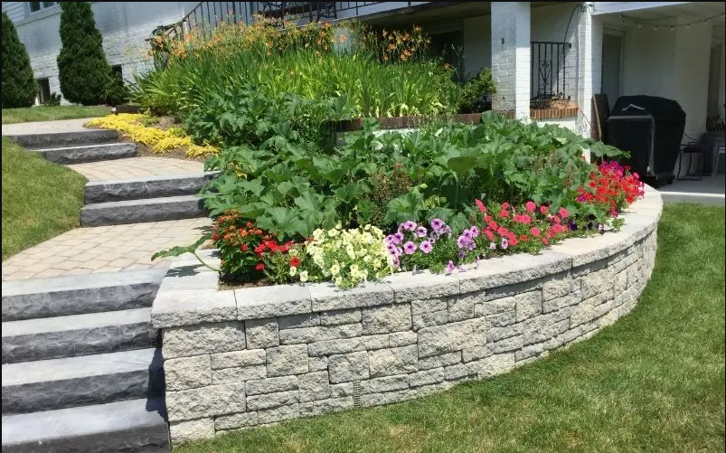 stone hardscape with flower beds and steps